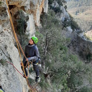 Kletterkurs am Fels im Klettergarten. Kletterlehrerin sichert.